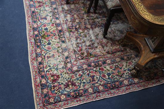 A Kirman ivory ground carpet,